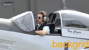 Tom Cruise gives a thumbs-up as he sits in his private plane with the cockpit open