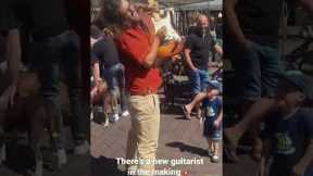 New guitarist in the making! Street performer inspires kid