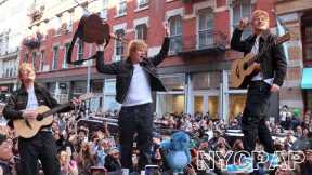 Ed Sheeran gives surprise performance from atop parked car on SoHo streetin new york city