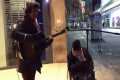 Homeless man joins busker for